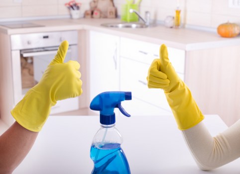 Professional domestic cleaner working in a Kennington home kitchen