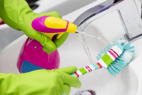 Deep cleaning kitchen and bathroom areas during a move-out clean