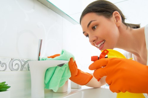 Professional cleaners maintaining shared office desks in Kennington